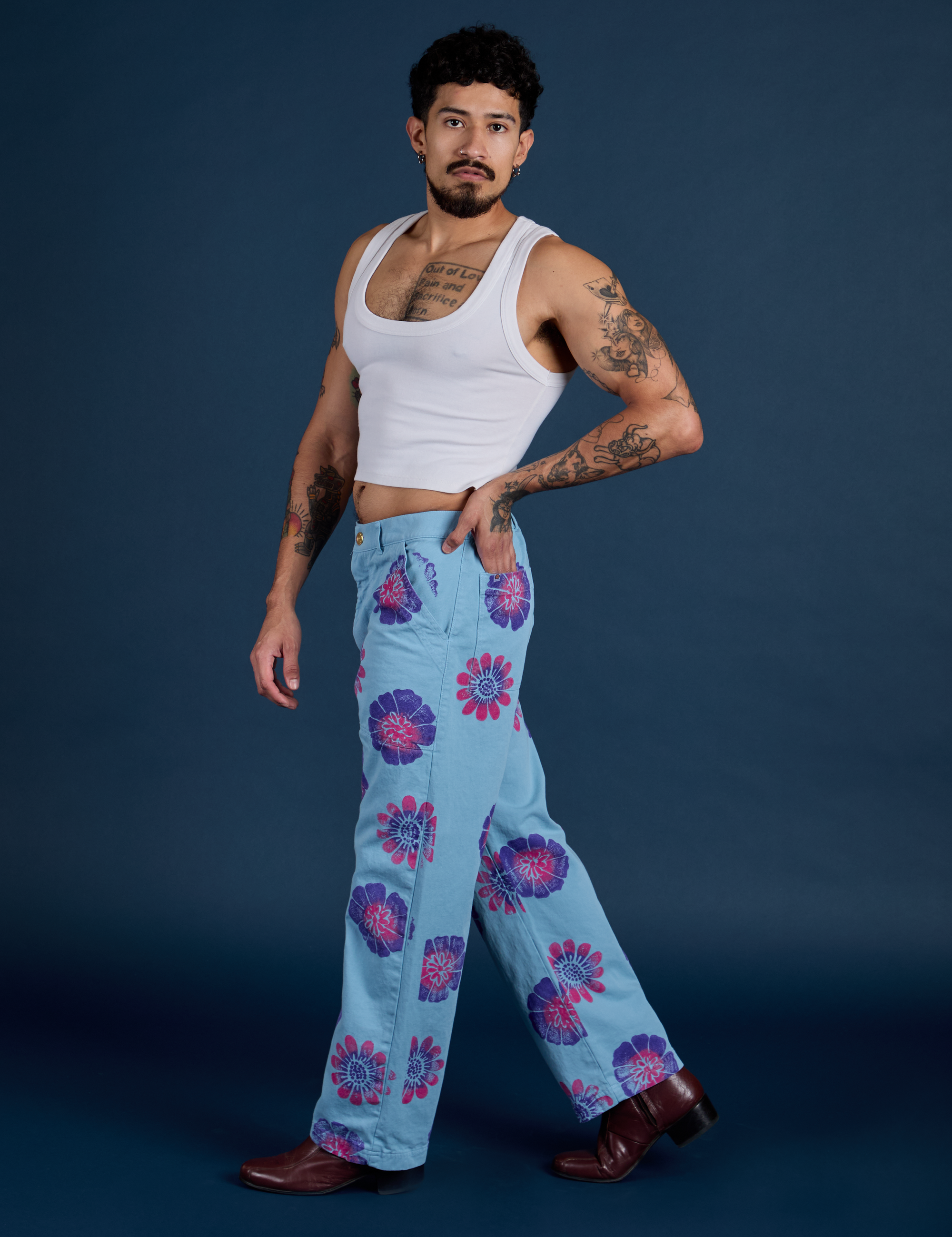 Side view of Floral Painted Work Pants in Blue and Cropped Tank in Vintage Tee White