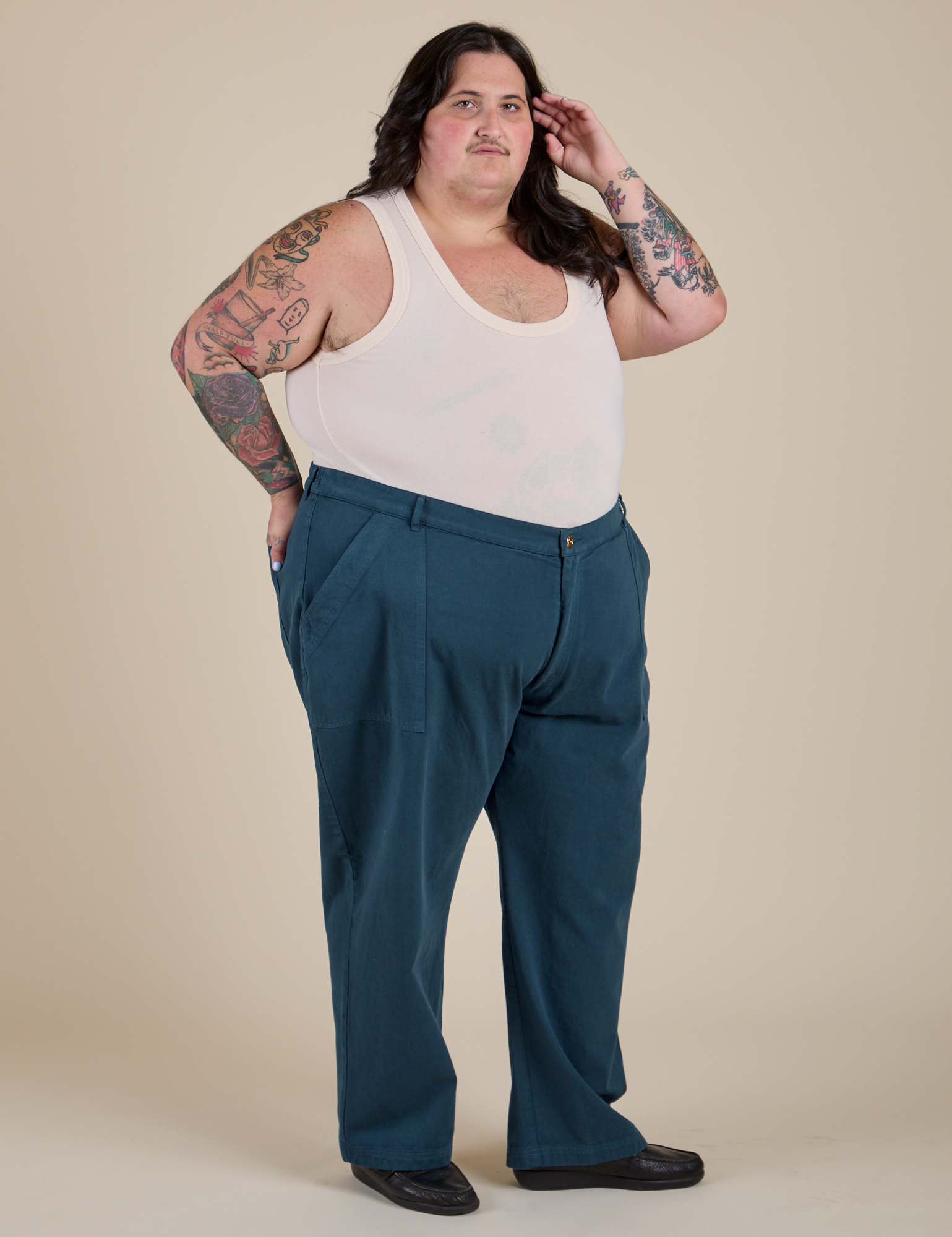 Angled front view of Work Pants in Lagoon and Tank Top in Vintage Tee Off-White on Sam