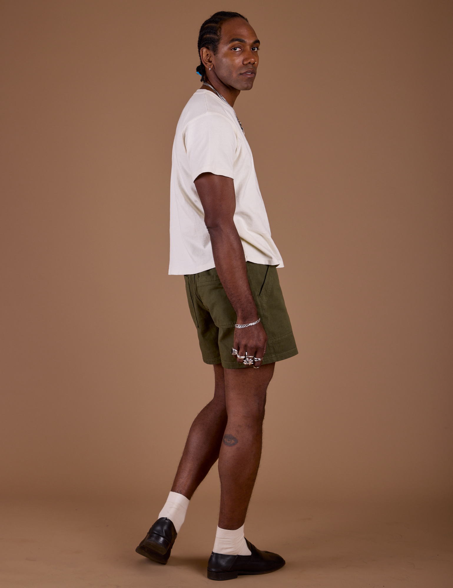 Side view of Classic Work Shorts in Surplus Green and Organic Vintage Tee in Vintage Off White on Jerrod