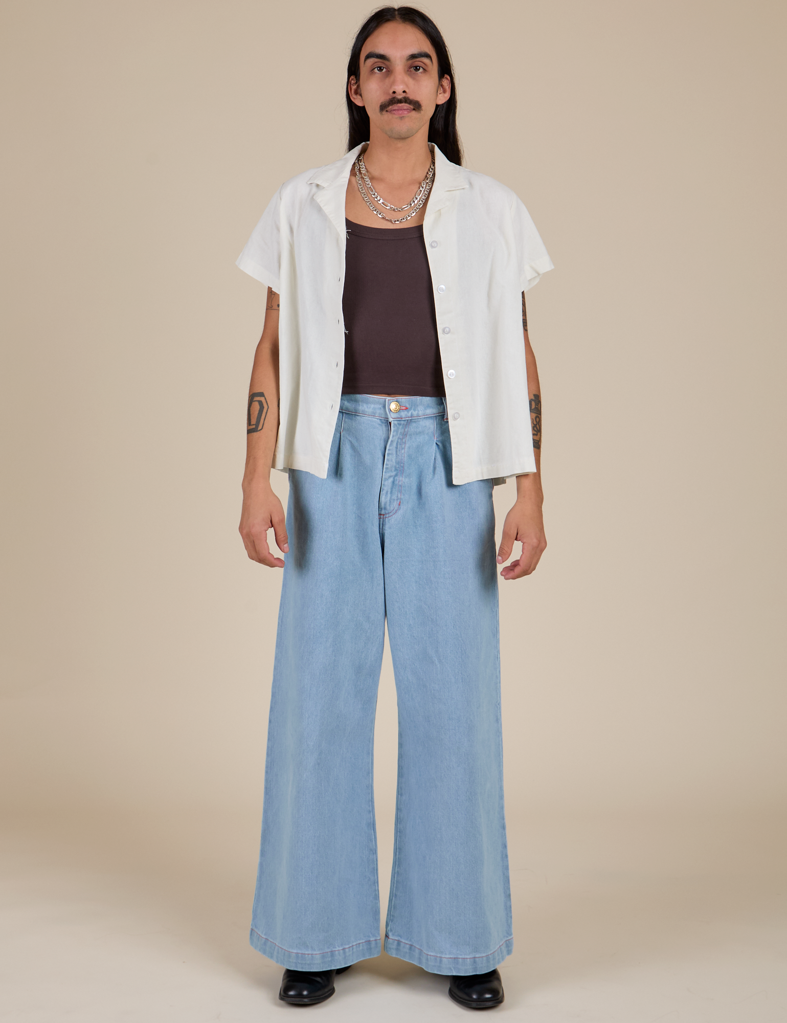 Anthony is wearing Pantry Button-Up in Vintage Tee White and light wash Indigo Wide Leg Trousers