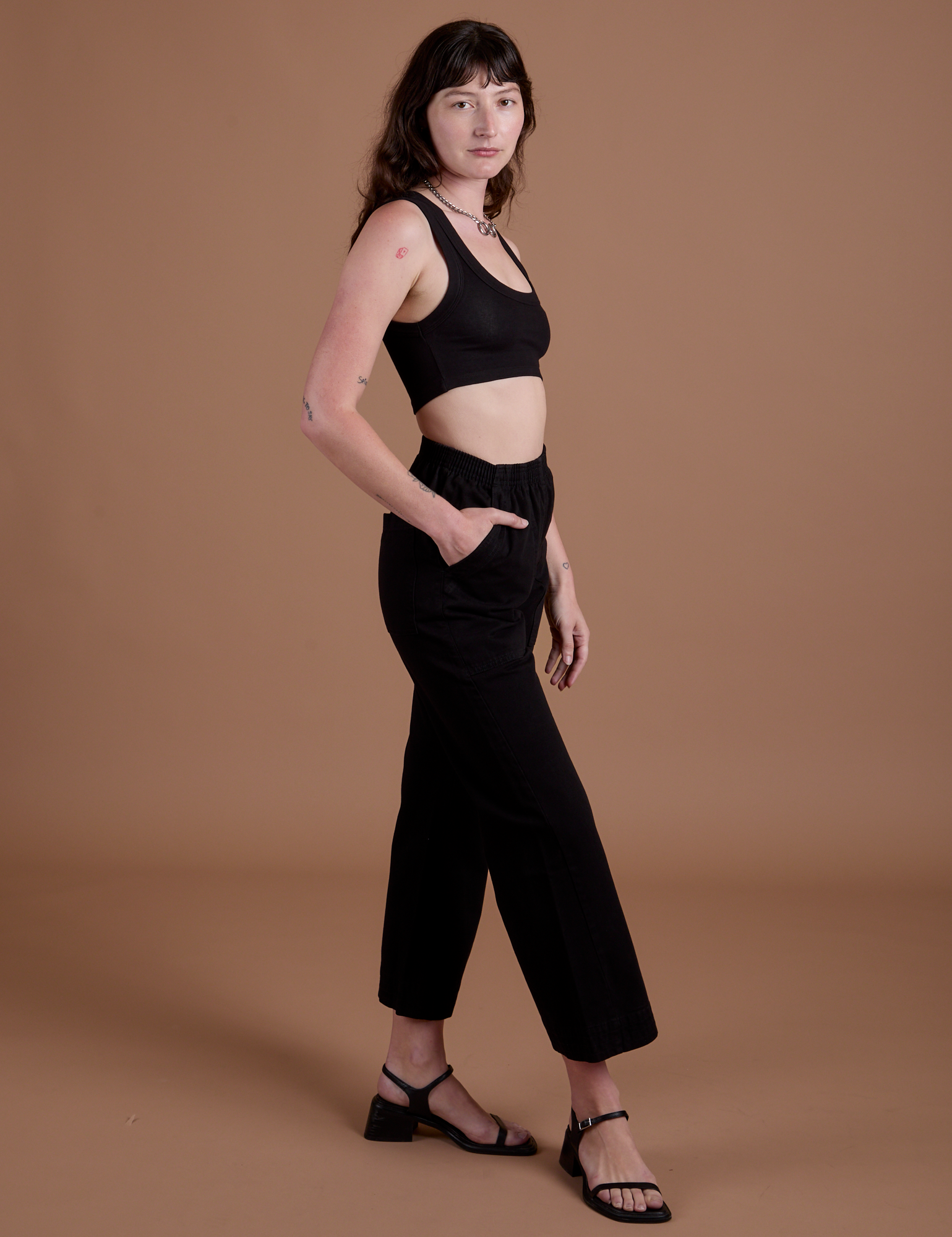 Side view of Action Pants in Basic Black and black Mini Tank on Alex