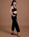 Side view of Action Pants in Basic Black and black Mini Tank on Alex