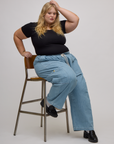 Juliet is wearing light wash denim drop pocket pants and Baby Tee in Basic Black