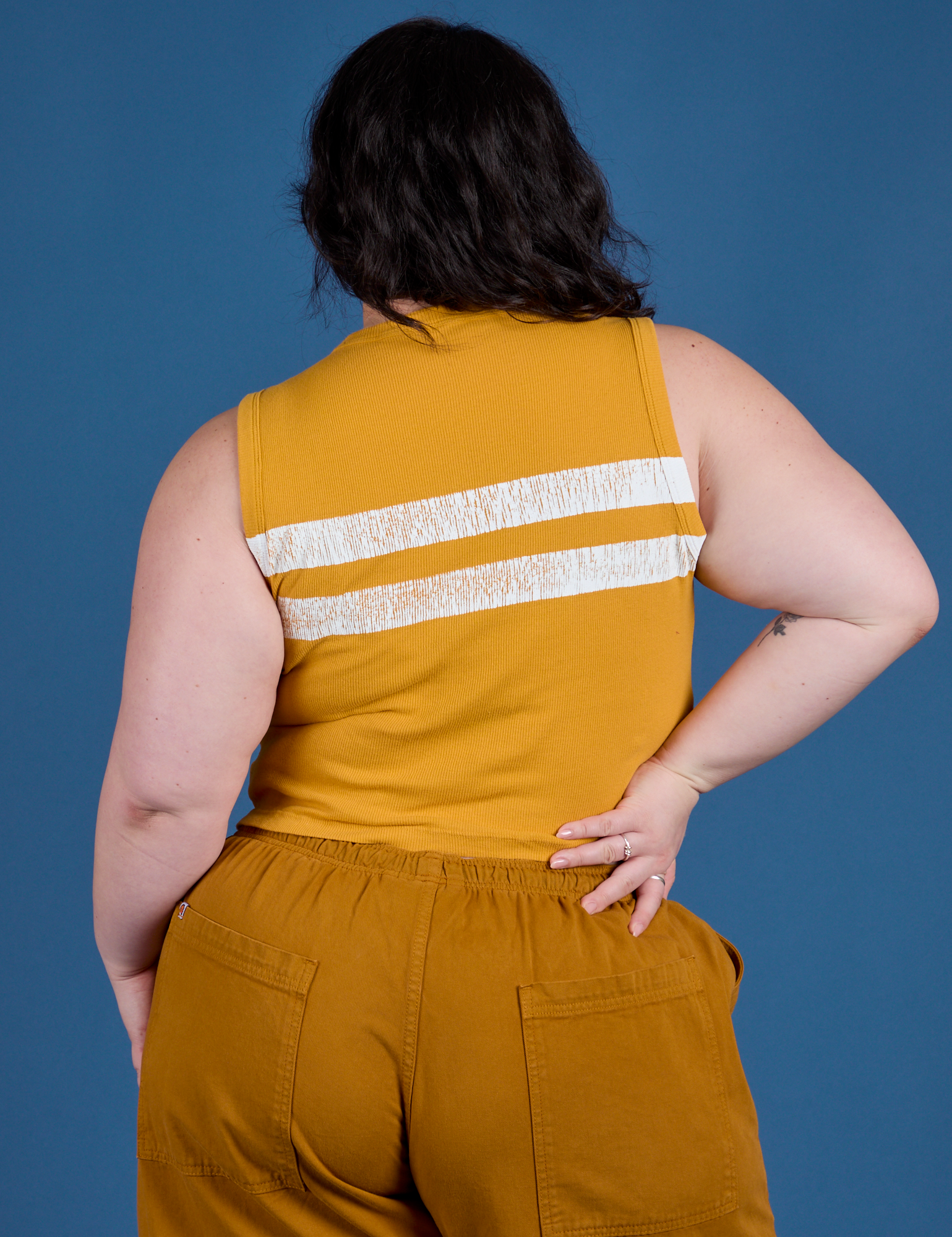 Painted Muscle Tee in Mustard Yellow back view on Ashley
