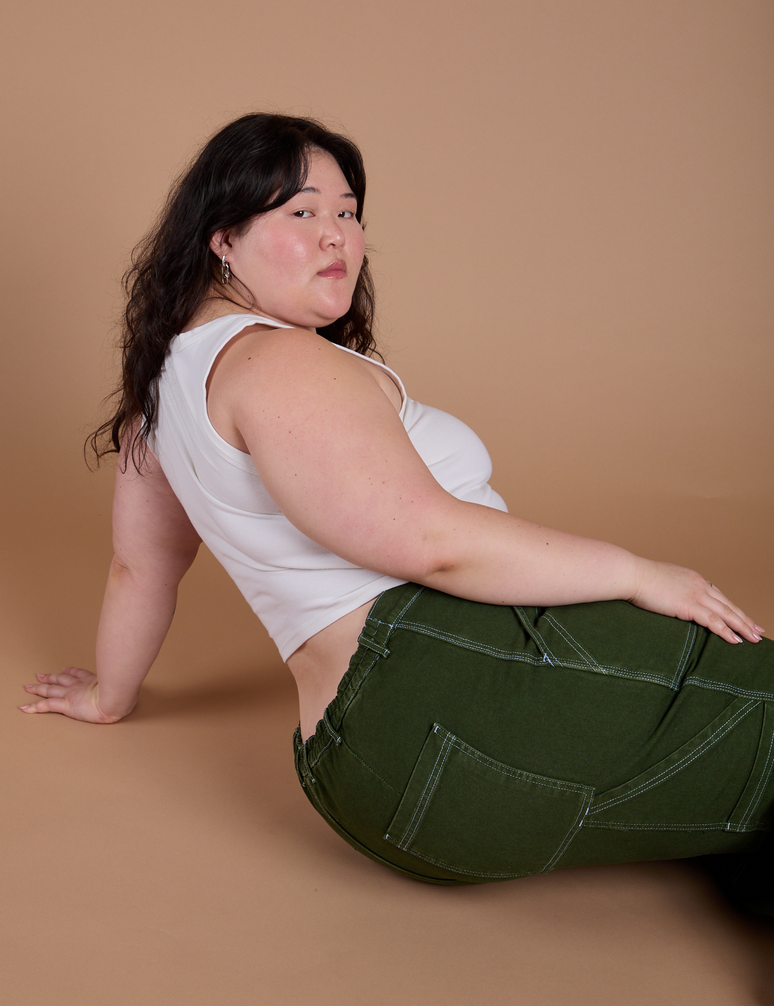 Carpenter Jeans in Evergreen and vintage tee white Cropped Tank worn by Ashley