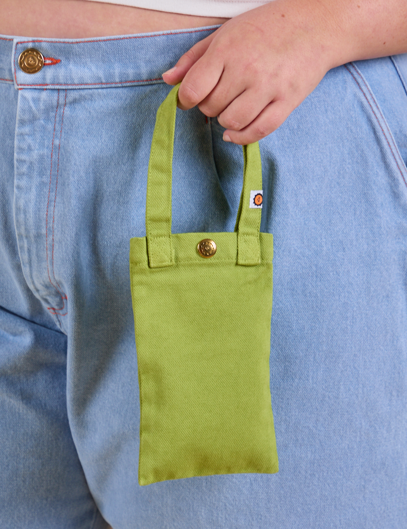 Cell Phone Tote in Gross Green held by model