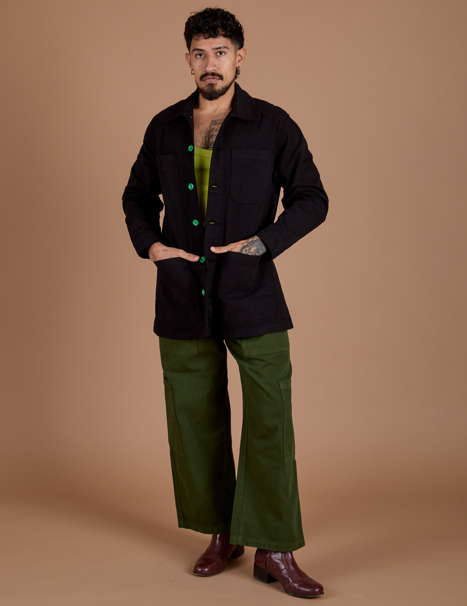 Jesse is wearing Ripstop Field Coat in Basic Black and evergreen Drop Pocket Cargo Pants