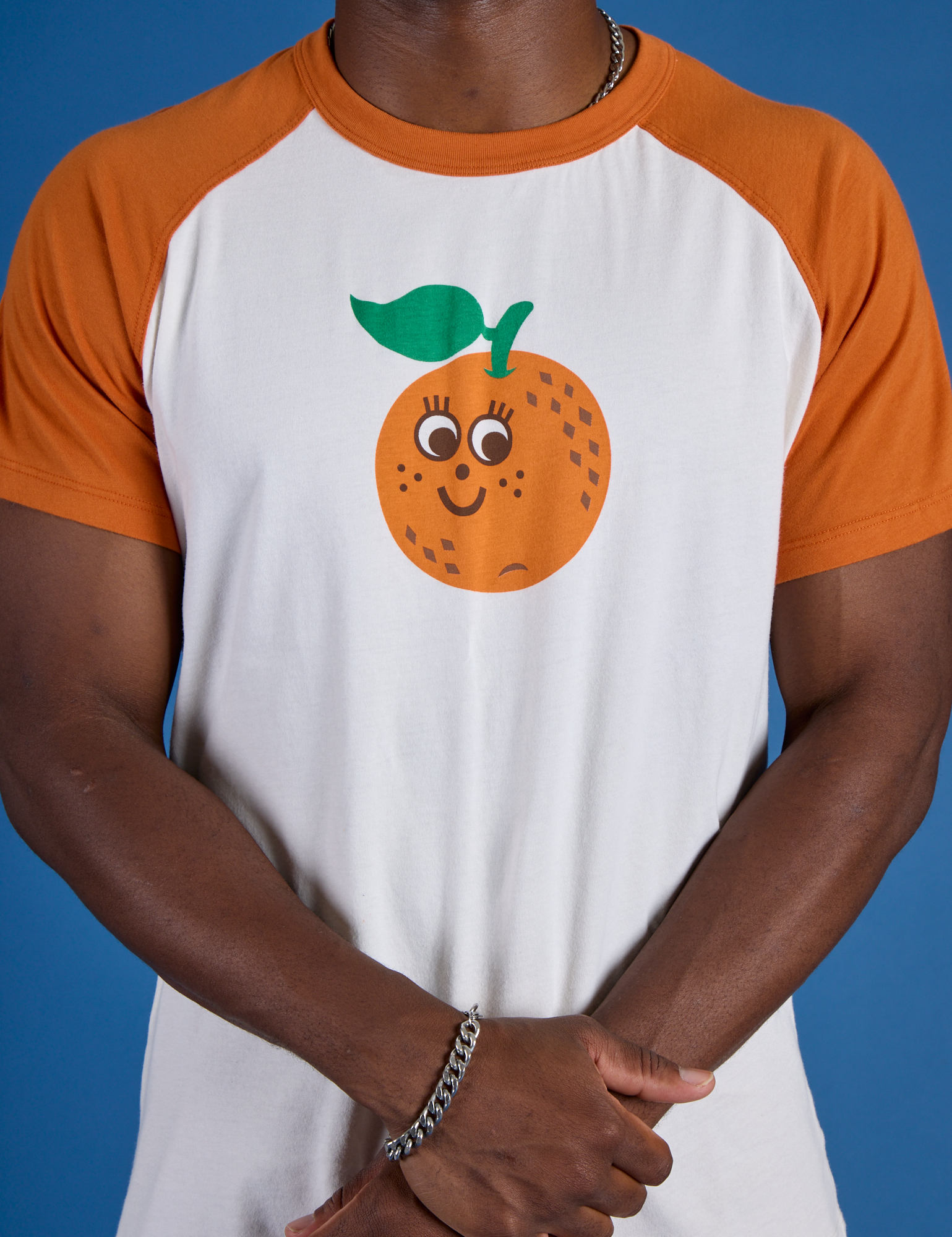 Produce Raglan Tee in Orange close up on Isaac
