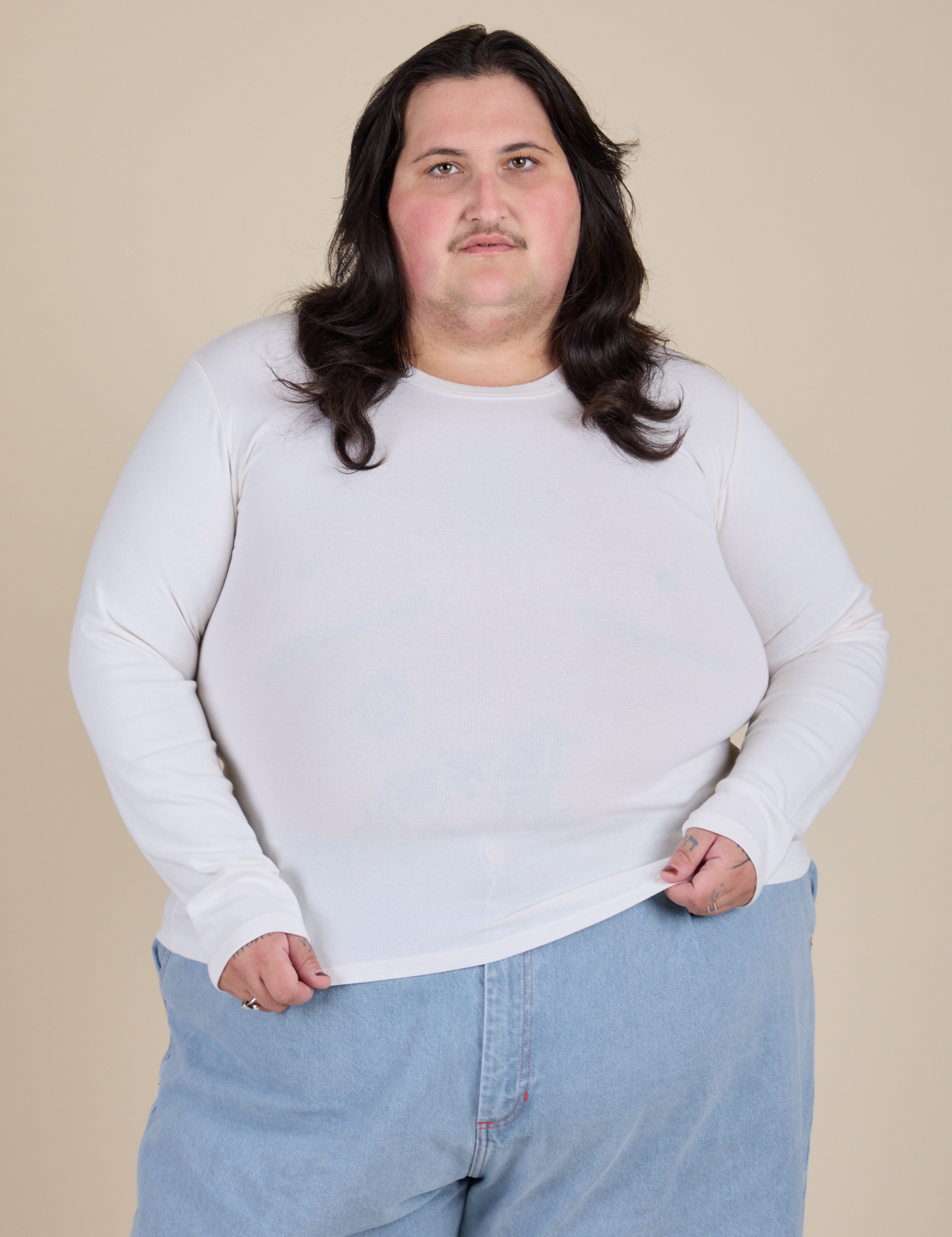 Sam is 5’10” and wearing XL Long Sleeve Baby Tee in Vintage Tee Off-White 