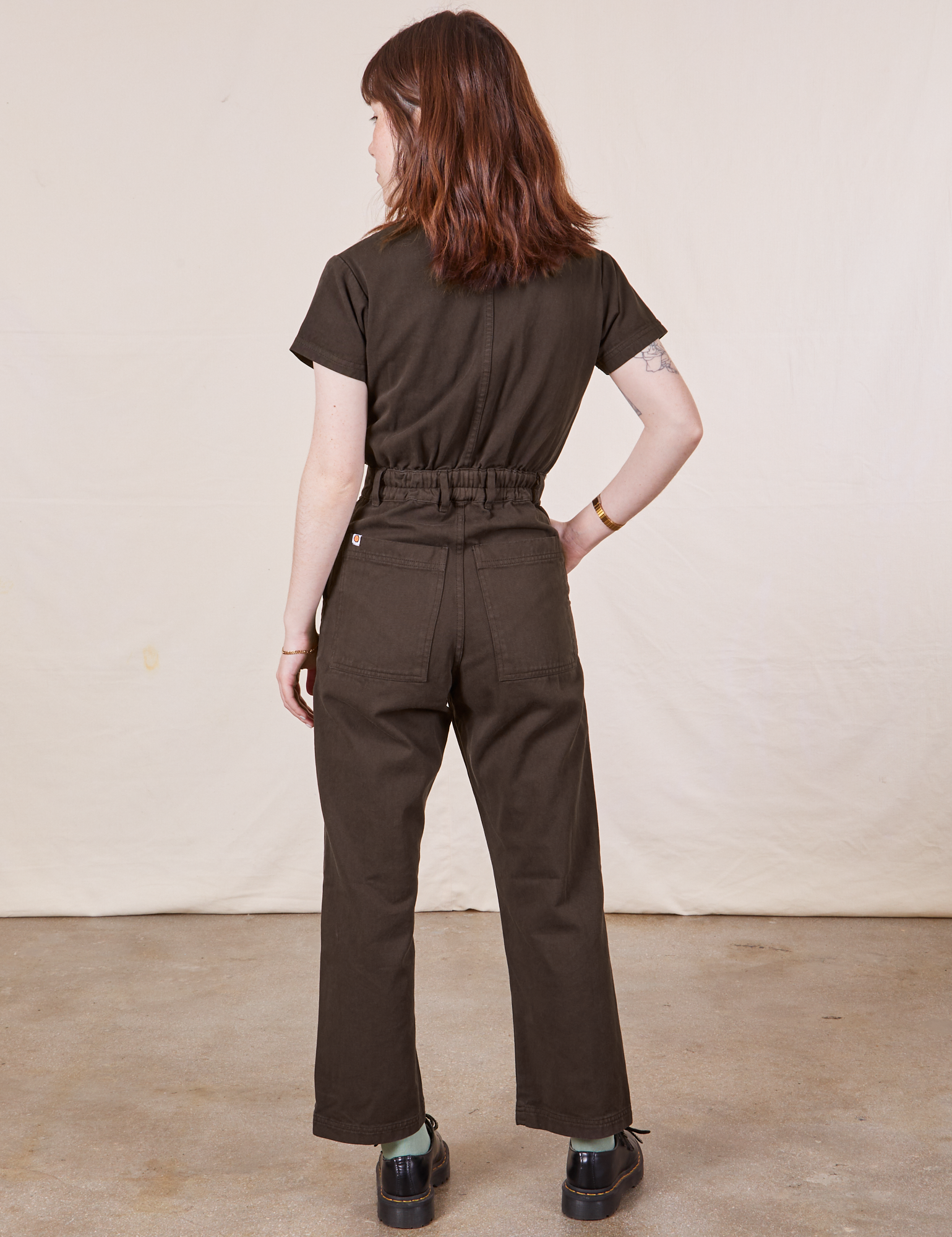 Petite Short Sleeve Jumpsuit in Espresso Brown back view on Hana