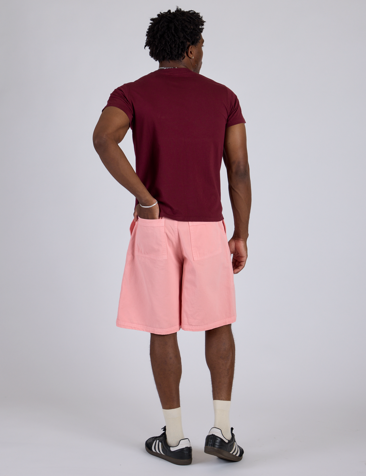 Back view of Longline Work Shorts in Baby Pink and red wine Organic Vintage Tee on Isaac