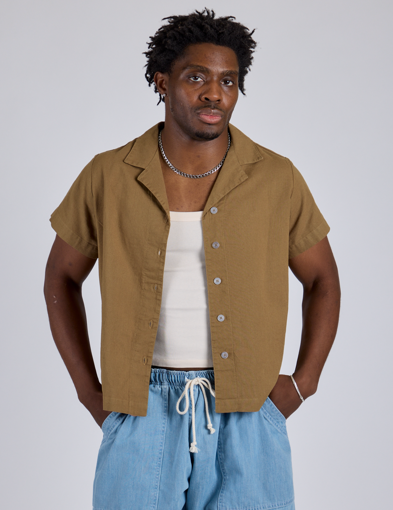 Isaac is wearing Pantry Button-Up in Desert Brown