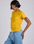Angled front view of Jr. Varsity Tee in Sunshine Yellow on Kira