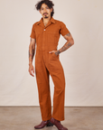 Jesse is wearing Short Sleeve Jumpsuit in Burnt Terracotta