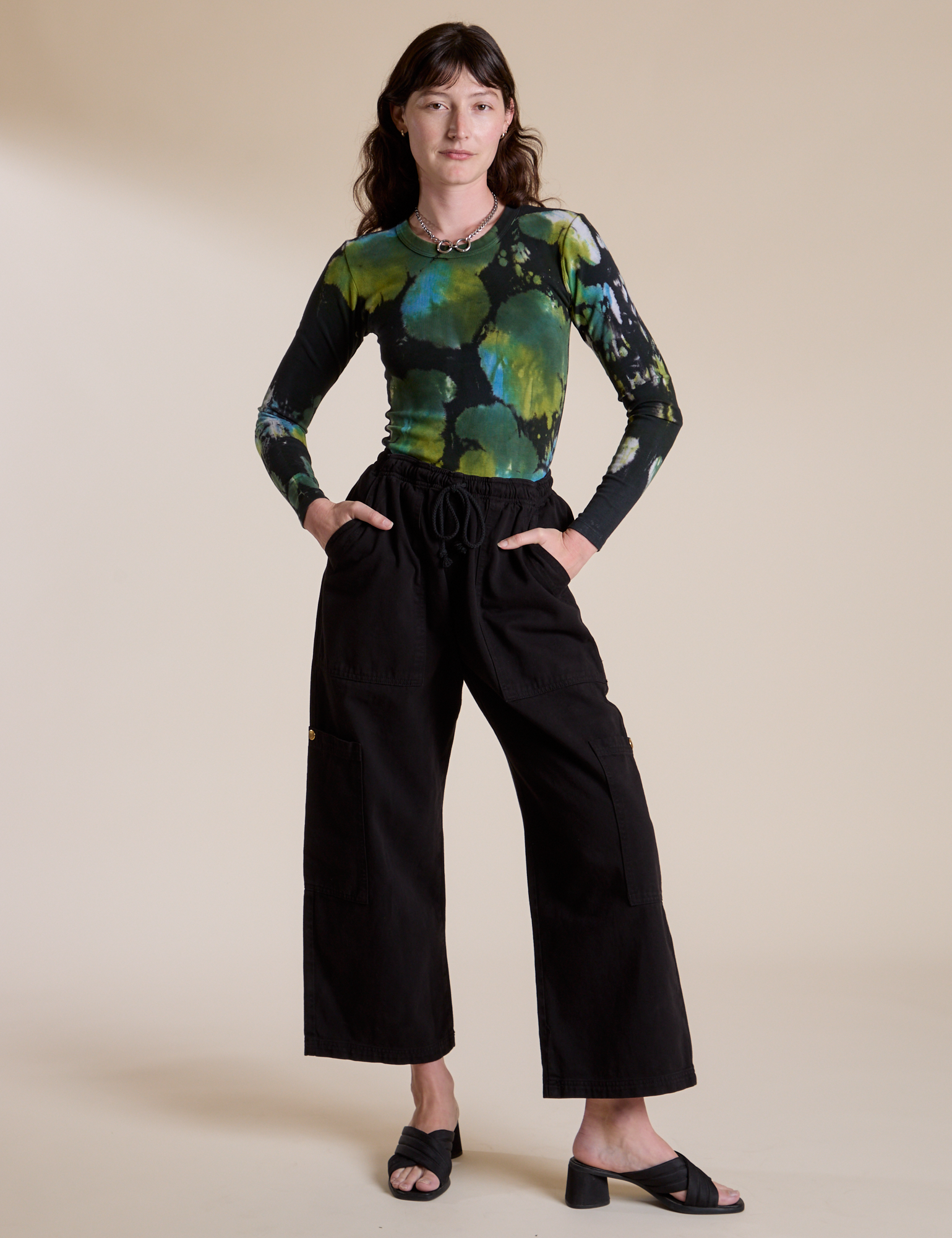 Alex is wearing Long Sleeve Baby Tee in Green Pool and black Drop Pocket Cargo Pants