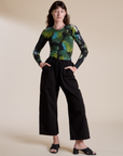 Alex is wearing Long Sleeve Baby Tee in Green Pool and black Drop Pocket Cargo Pants