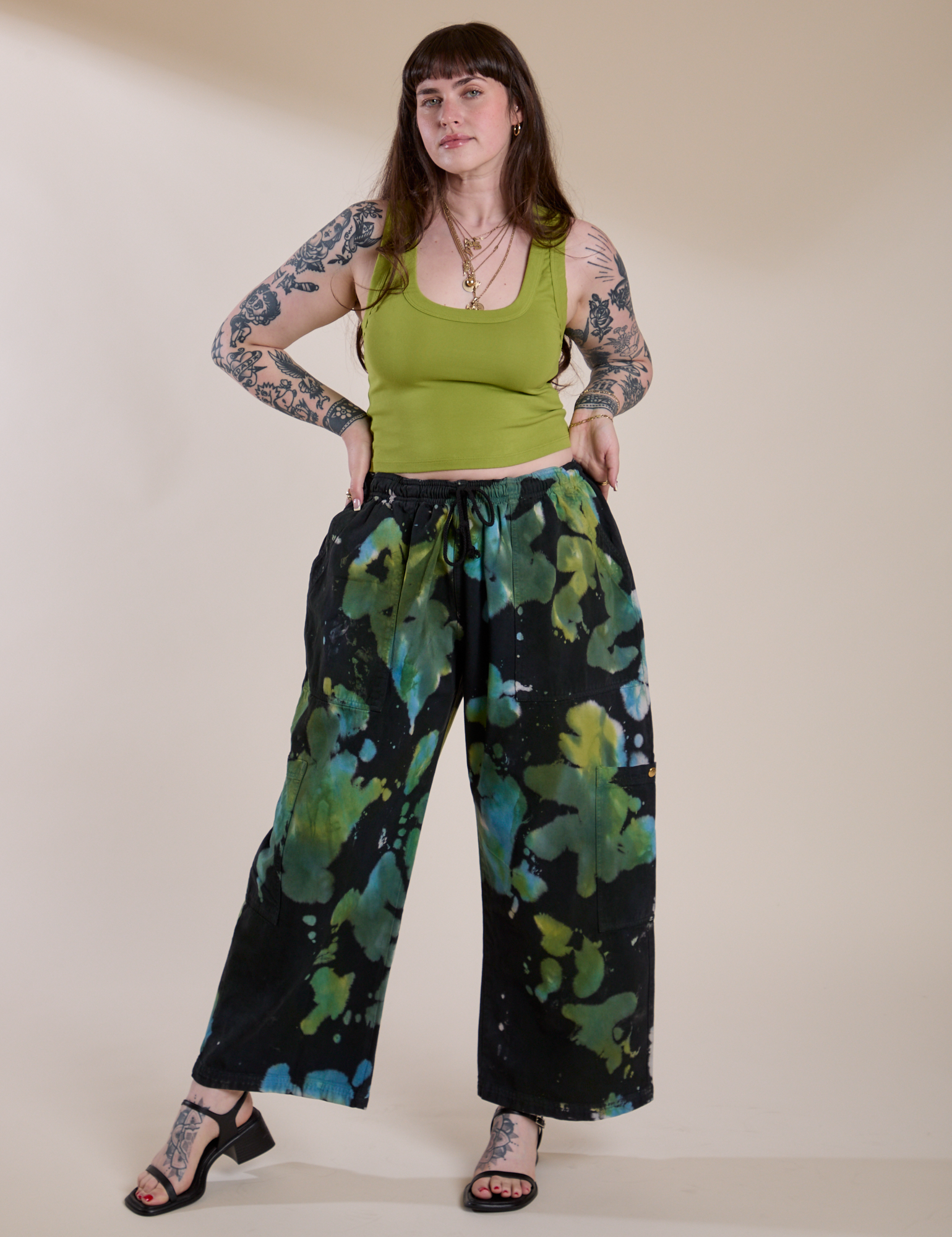 Sydney is wearing Magic Waters Drop Pocket Pants in Green Pool and gross green Cropped Tank