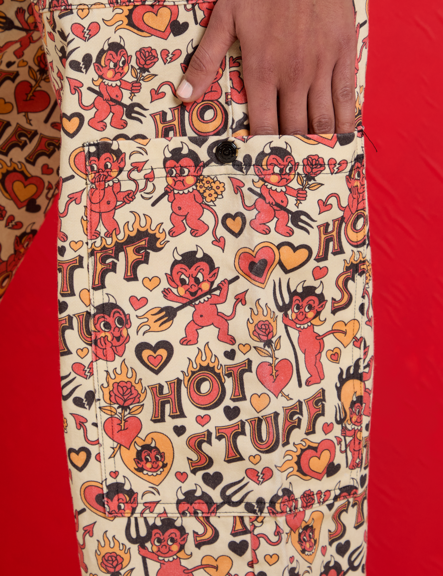 Close up of Shahana's hand on the pant leg pocket of Hot Stuff Drop Pocket Cargo Pants