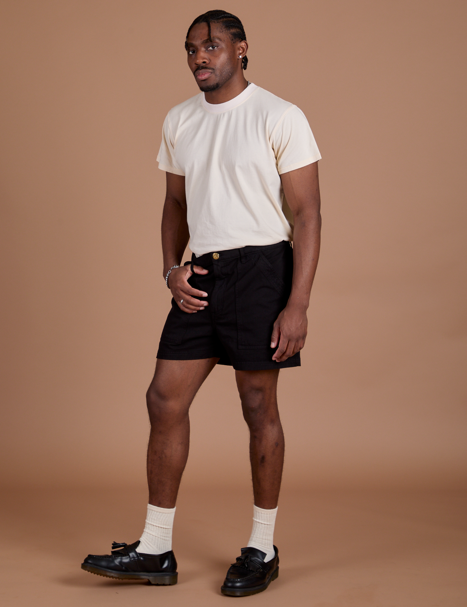 Angled front view of Classic Work Shorts in Basic Black and Organic Vintage Tee in Vintage Off White on Isaac
