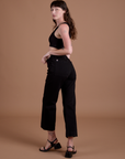 Angled back view of  Action Pants in Basic Black on Alex