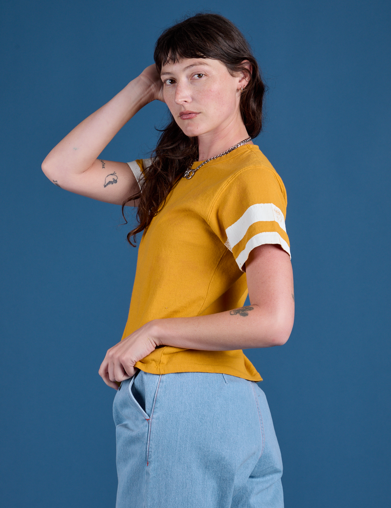Painted Burly Tee in Mustard Yellow side view on Alex