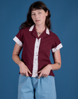 Alex is wearing a buttoned up Painted Pantry Button-Up in Red Wine