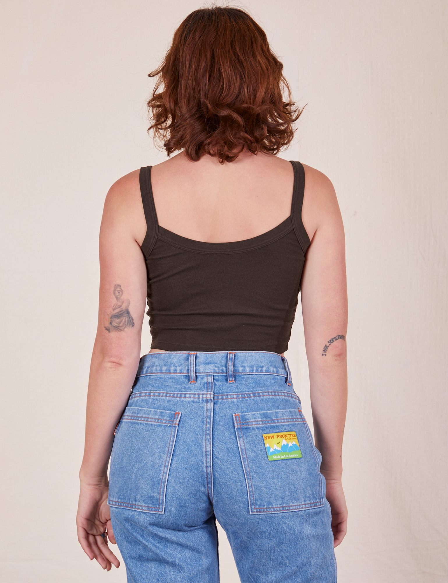 Back view of Cropped Cami in Espresso Brown and light wash Frontier Jeans worn by Alex
