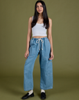 Anjaline 5'7" is and wearing XXS Denim Drop Pocket Pants in Light Wash paired with vintage tee white Cropped Tank