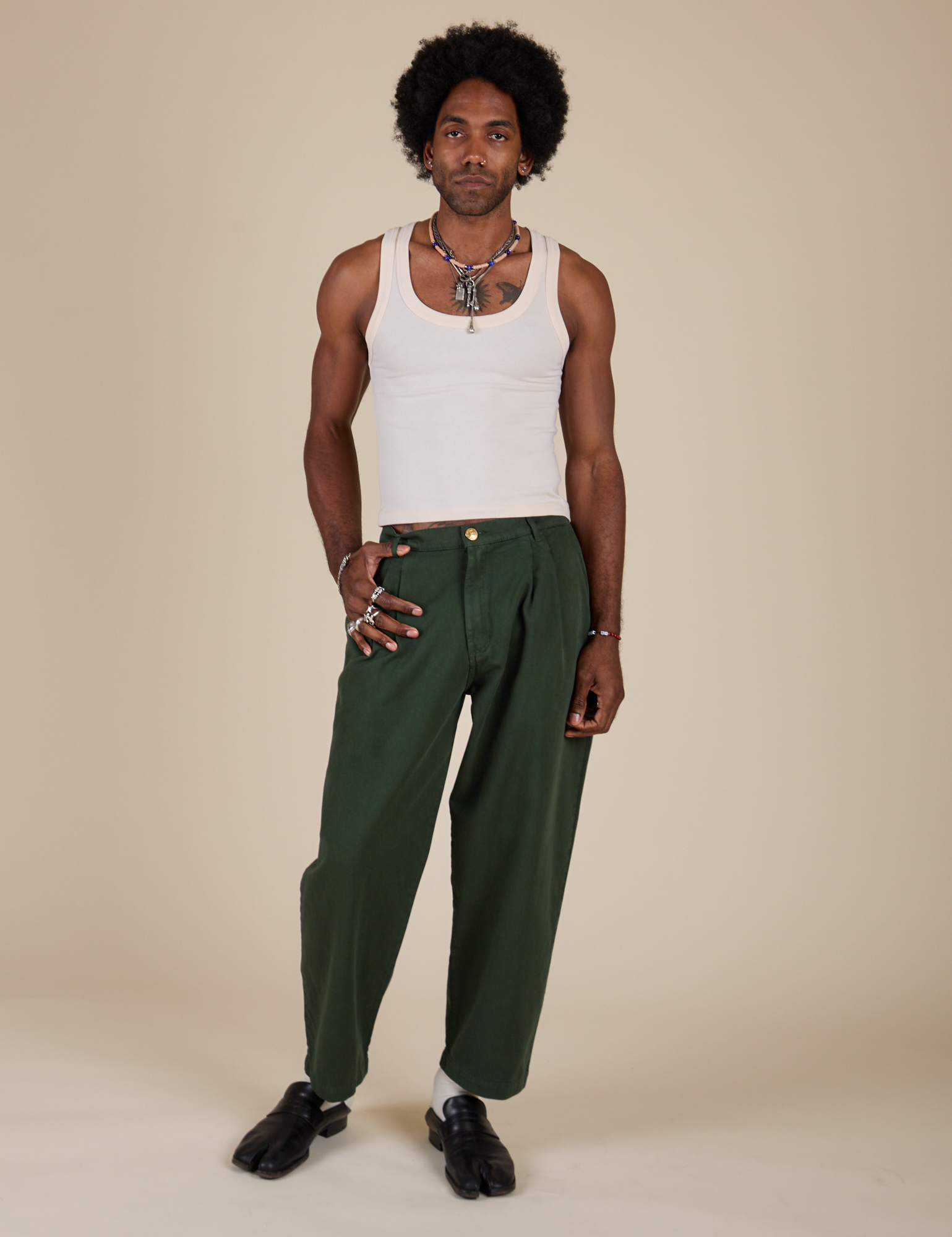 Jerrod is 6'3" and wearing M Heavyweight Trousers in Swamp Green paired with Tank Top in Vintage Tee Off-White