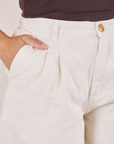 Front close up of Heavyweight Trousers in Vintage Tee Off-White. Tiara has her hand in the pocket.