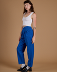 Side view of Heritage Trousers in Royal Blue and vintage tee white Cropped Tank on Alex