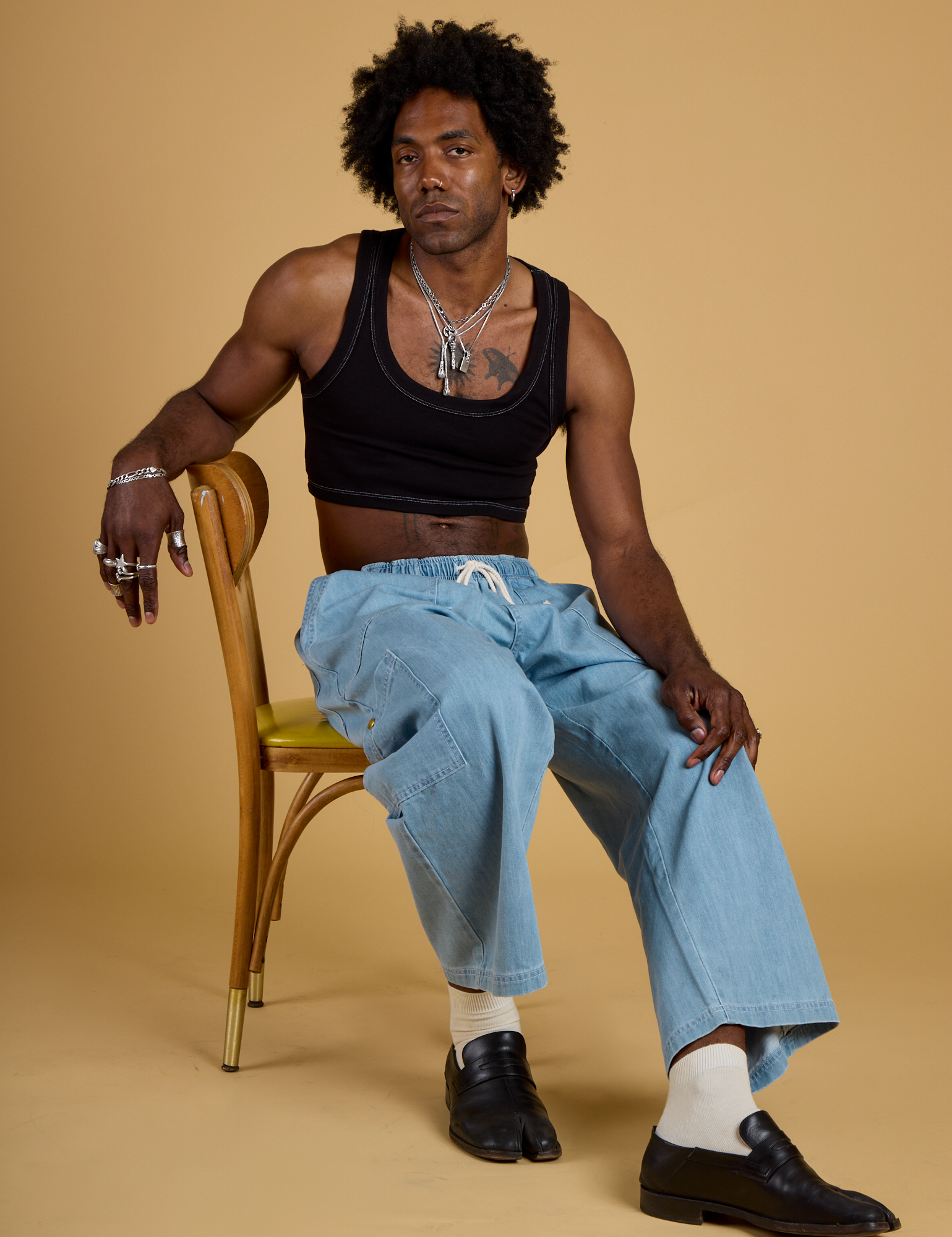 Jerrod is wearing Contrast Stitch Mini Tank in Basic Black and light wash Denim Drop Pocket Pants