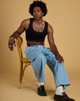 Jerrod is wearing Contrast Stitch Mini Tank in Basic Black and light wash Denim Drop Pocket Pants
