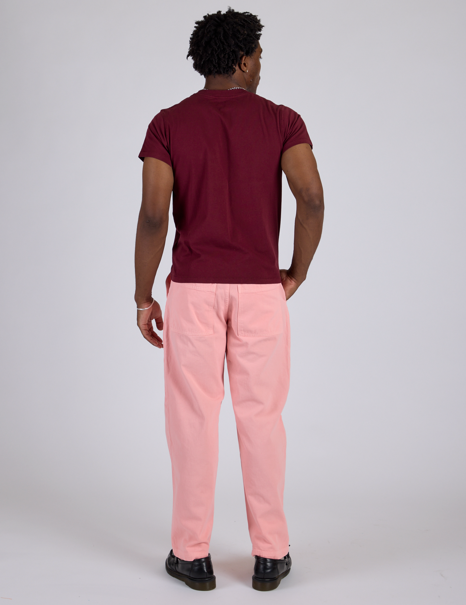 Back view of Work Pants in Baby Pink and red wine Organic Vintage Tee on Isaac