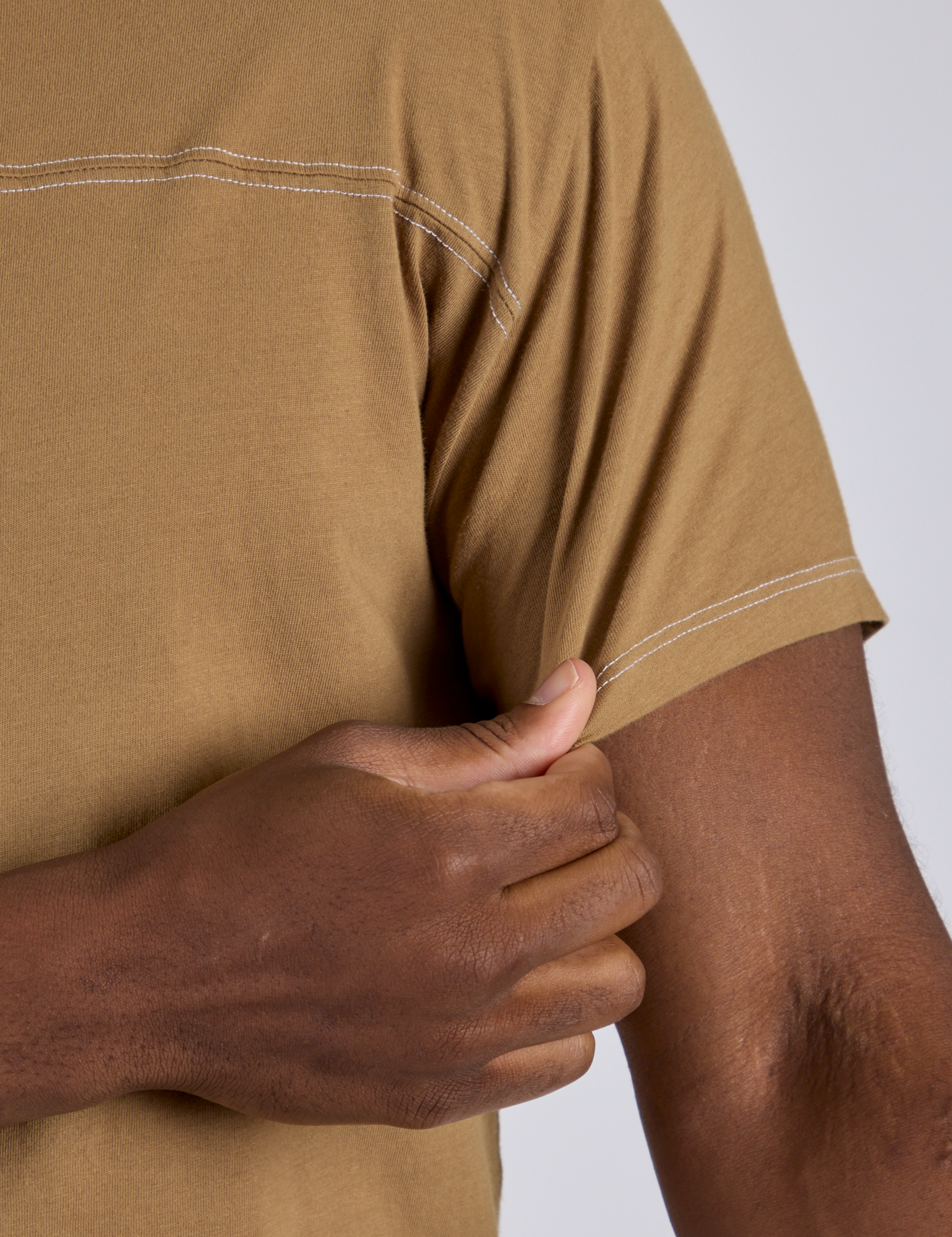 Close up of Jr. Varsity Tee in Desert Brown sleeve on Isaac