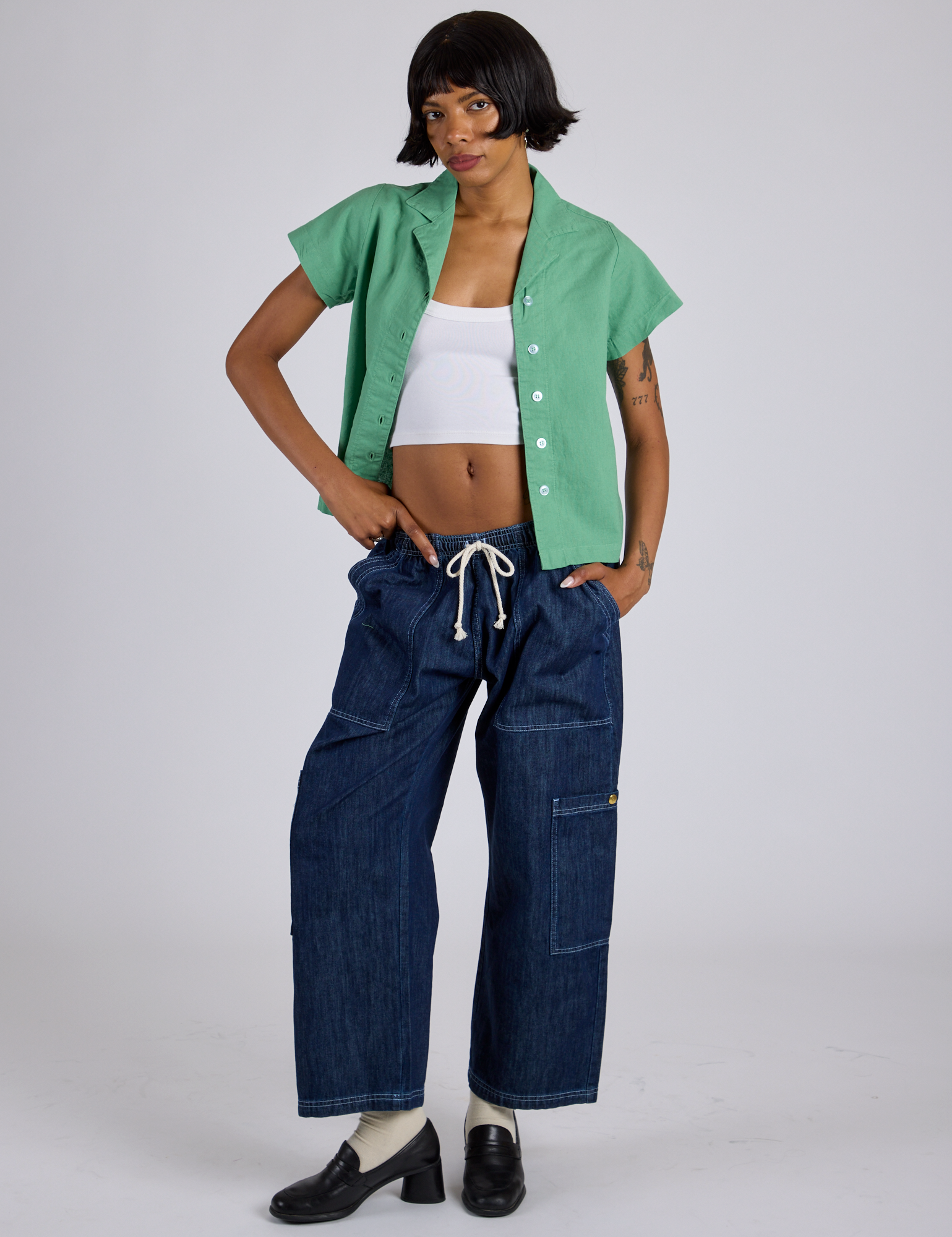 Kira is wearing Pantry Button-Up in Seafoam Green and dark wash Denim Drop Pocket Pants