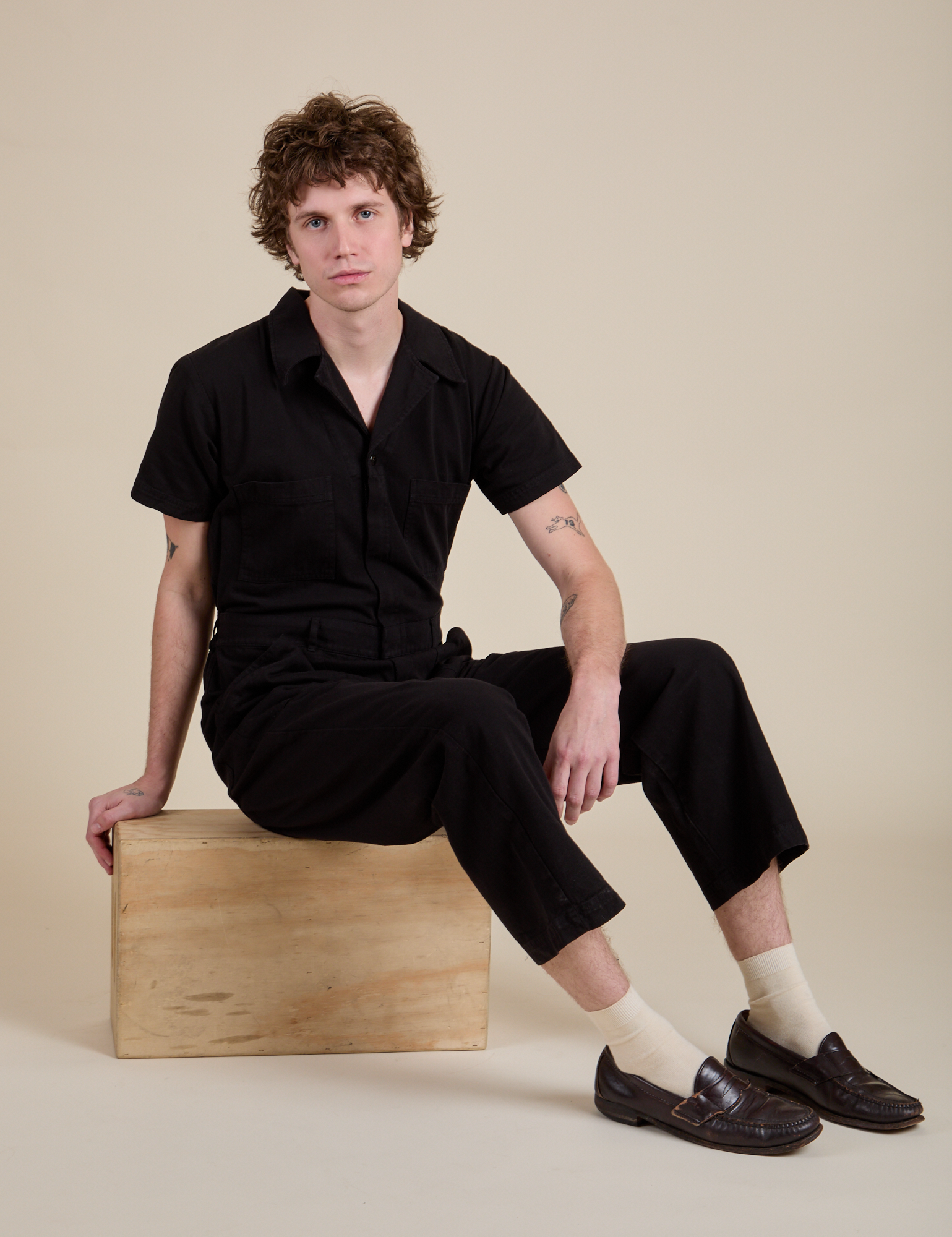 Quinn is wearing Short Sleeve Jumpsuit in Basic Black
