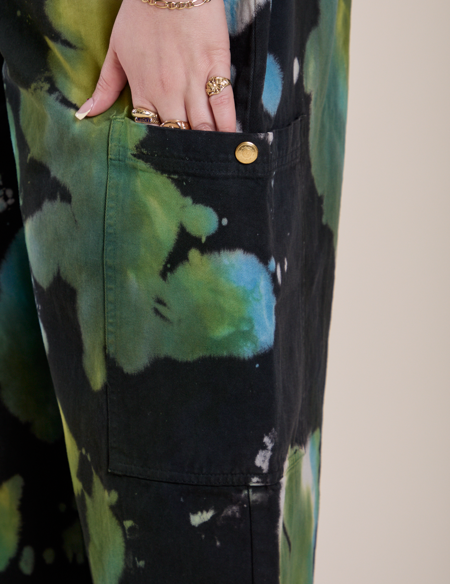 Close up of Sydney's hand in the Magic Waters Drop Pocket Pants in Green Pool pant leg pocket