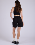 Pleated Trouser Shorts in Basic Black back view on Alex