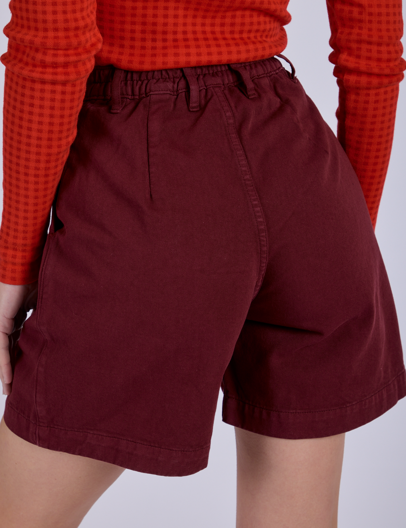 Pleated Trouser Shorts in Red Wine back view close up on Alex
