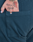 Close up of Sam's hand in the back pocket of Work Pants in Lagoon