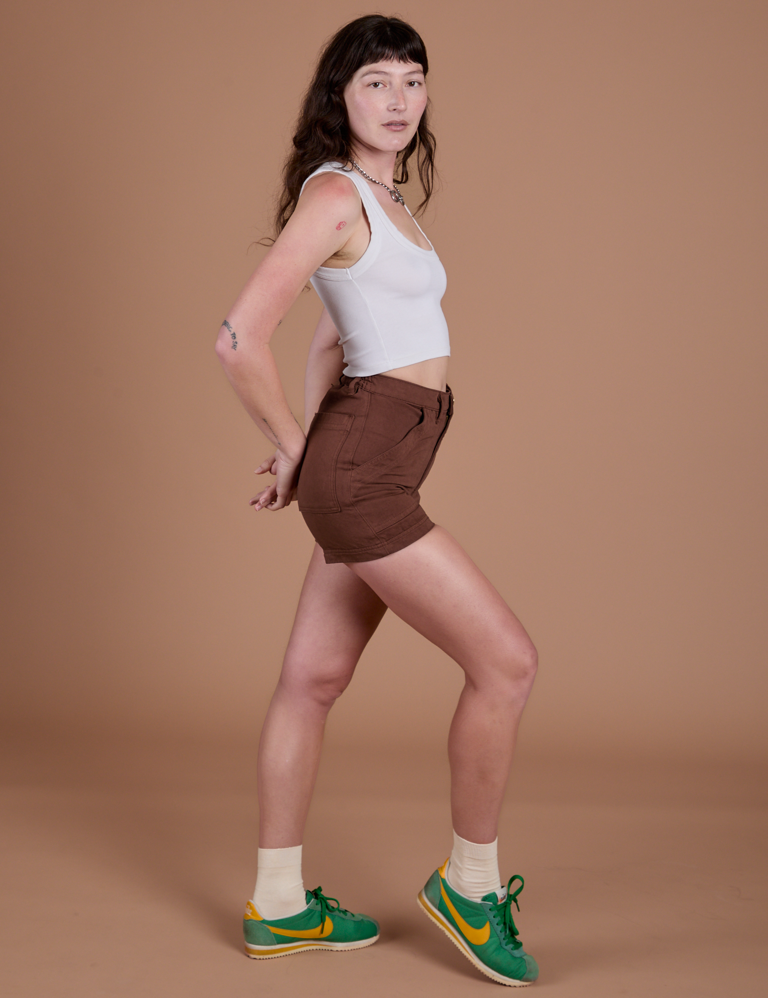 Side view of Classic Work Shorts in Fudgesicle Brown and Cropped Tank in Vintage Tee White on Alex