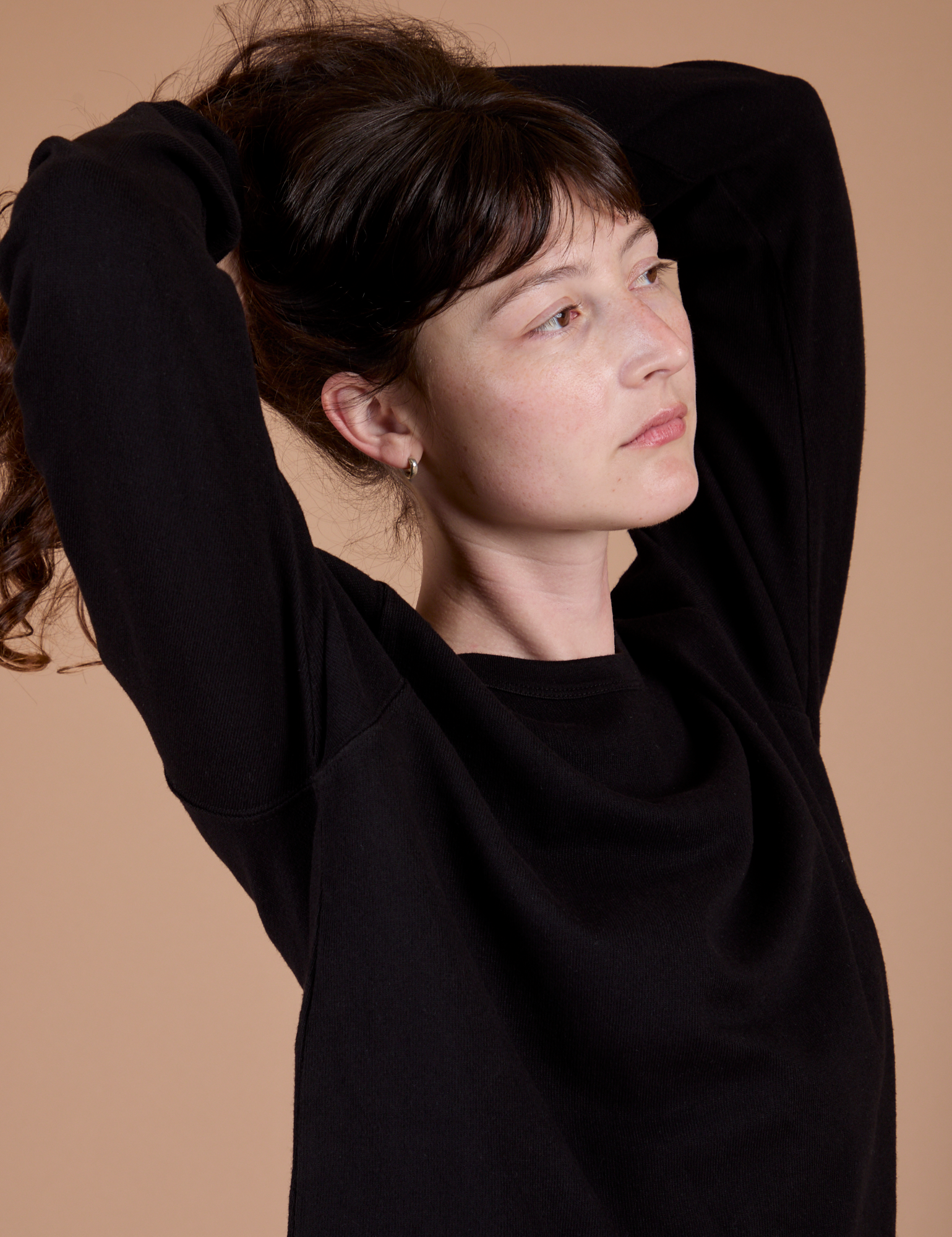 Long Sleeve Burly Tee in Basic Black angled front view close up on Alex