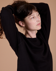 Long Sleeve Burly Tee in Basic Black angled front view close up on Alex