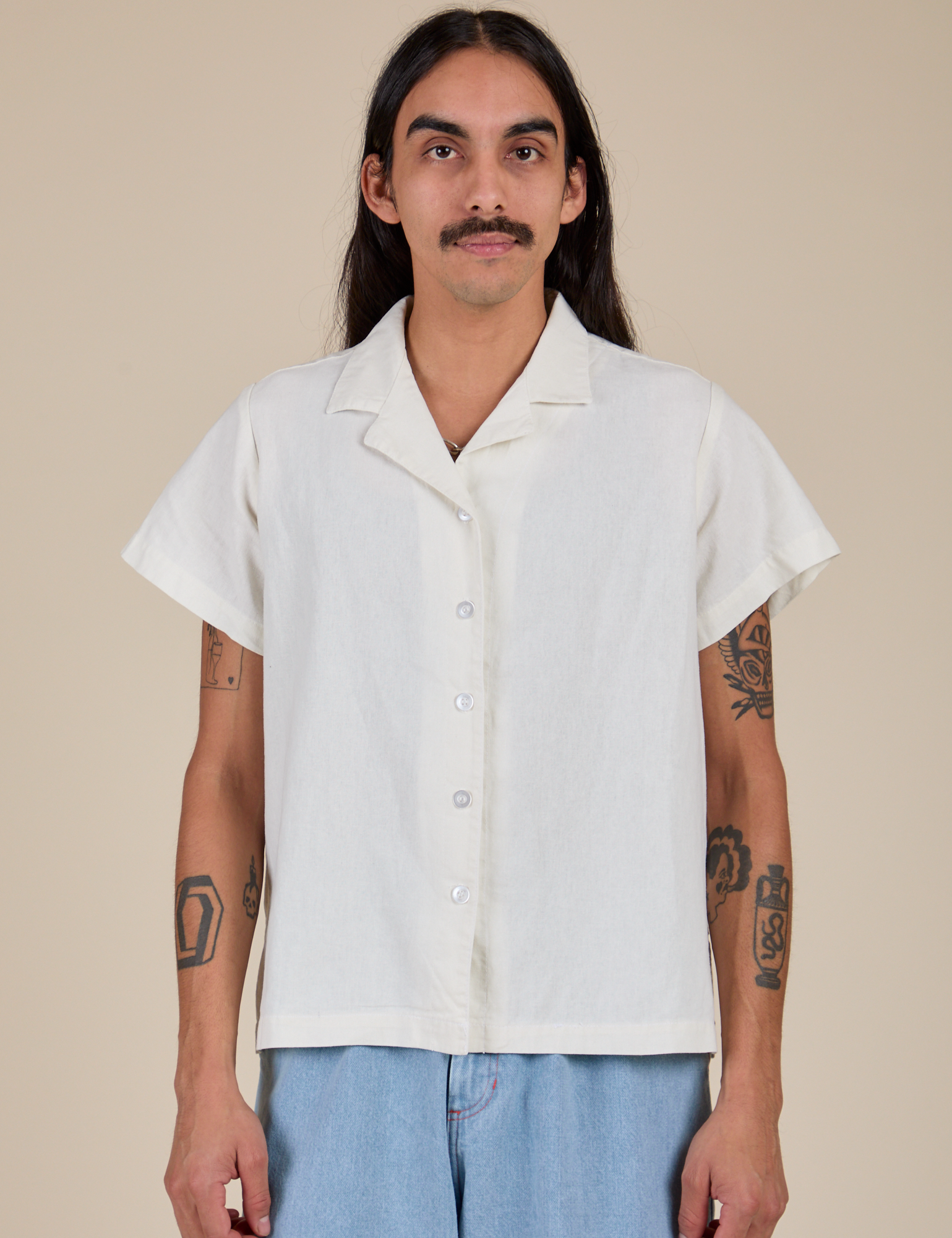 Anthony is wearing a buttoned up Pantry Button-Up in Vintage Tee White