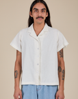 Anthony is wearing a buttoned up Pantry Button-Up in Vintage Tee White
