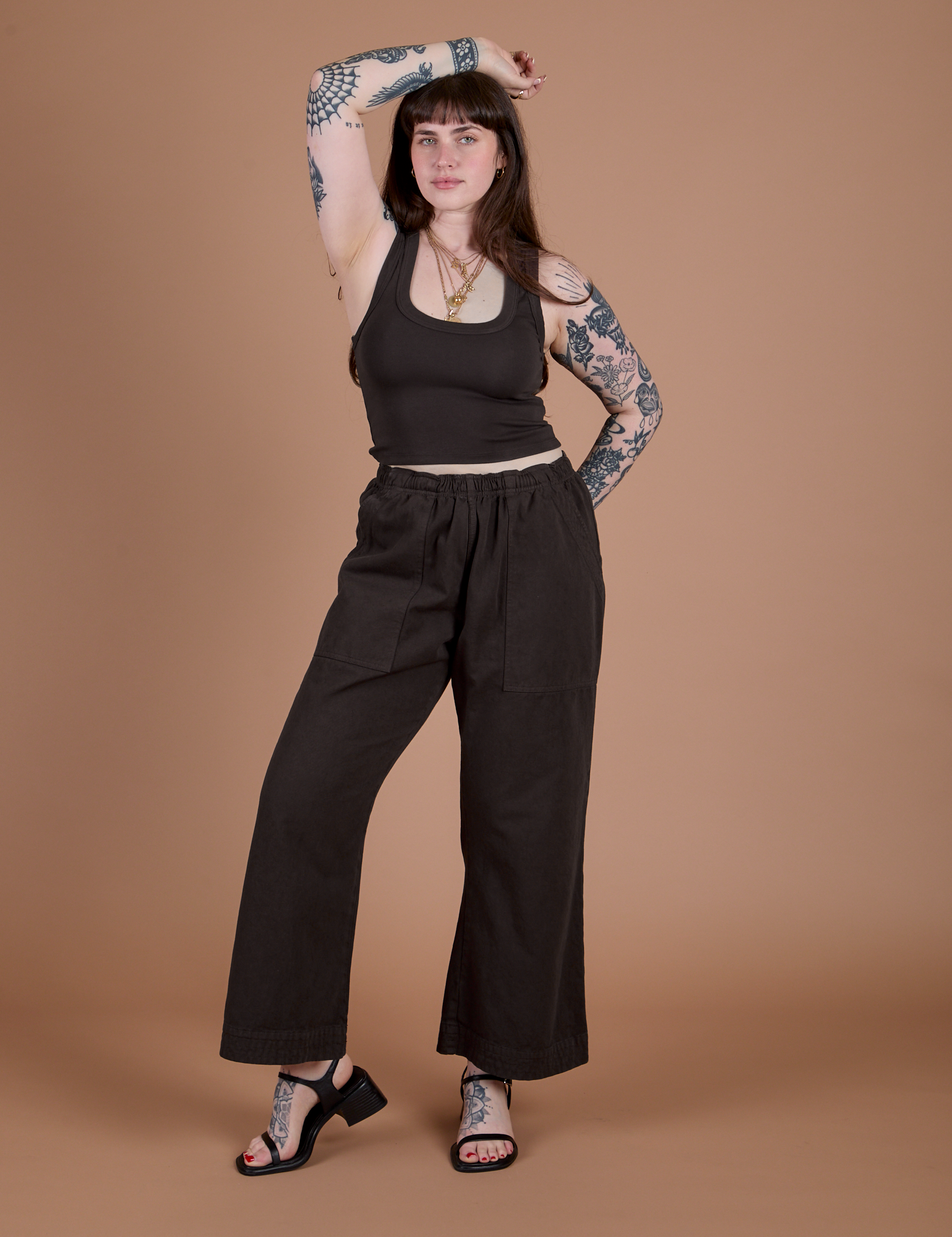 Sydney is 5’9” and wearing M Work Pants in Espresso Brown paired with matching Cropped Tank