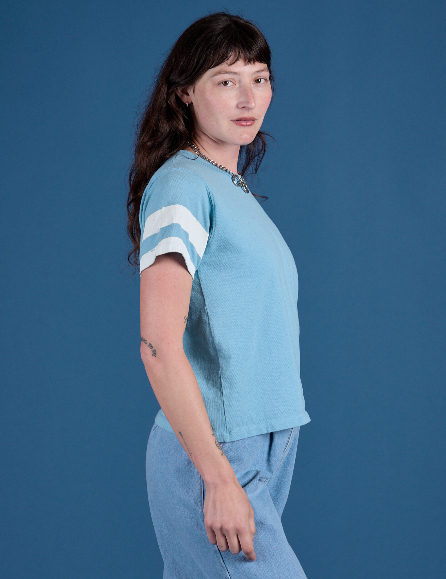 Painted Burly Tee in Baby Blue side view on Alex