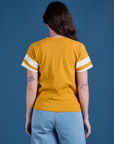 Painted Burly Tee in Mustard Yellow back view on Alex