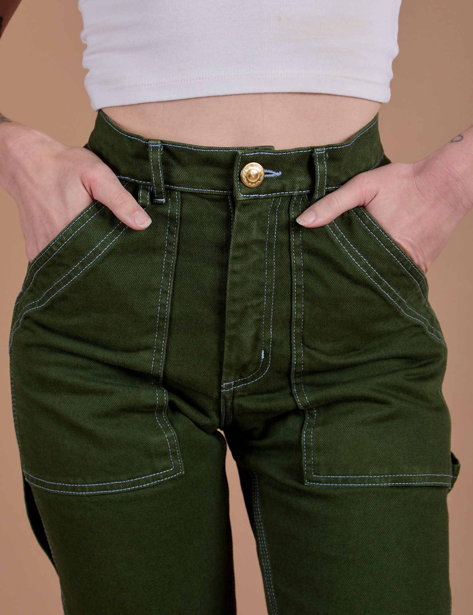 Front close up of Carpenter Jeans in Evergreen on Alex